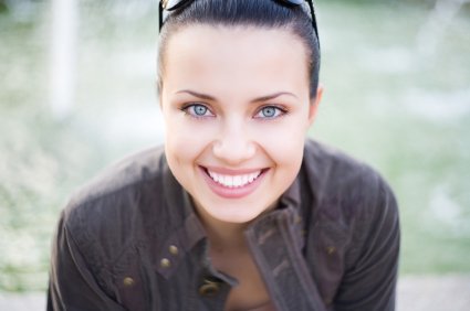 Girl smiles brightly after visiting the cosmetic dentist near Sparks MD.