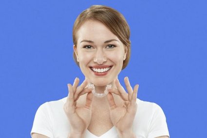 Girl shows off her Invisalign clear braces that she received from a dentist near Parkton, MD.